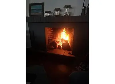 a fire in a brick fireplace in a room at La Morena 68 in Chiclana de la Frontera