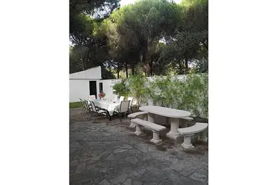 a picnic table and chairs with a table and benches at La Morena 68 in Chiclana de la Frontera