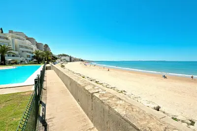 a view of a beach and the ocean at On Beach Deluxe Apartment with Pools and own Garden in El Puerto de Santa María