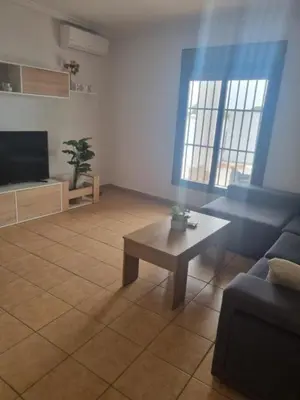 a living room with a couch and a coffee table at Casa piscina in Chiclana de la Frontera
