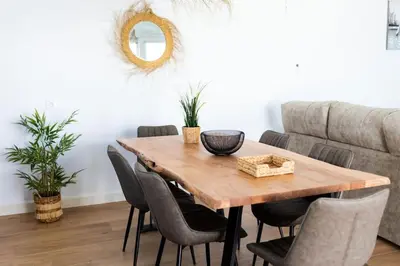 a dining room with a wooden table and chairs at Bisonte A in Chiclana de la Frontera