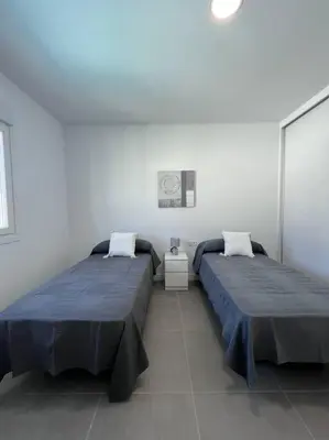 two beds sitting next to each other in a room at GRANIZO A in Chiclana de la Frontera