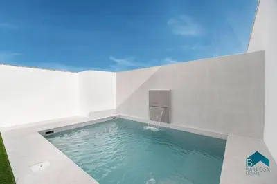 a swimming pool in the corner of a building at GRANIZO A in Chiclana de la Frontera