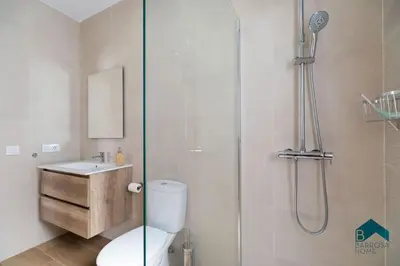 a bathroom with a shower and a toilet and a sink at Bisonte B in Chiclana de la Frontera