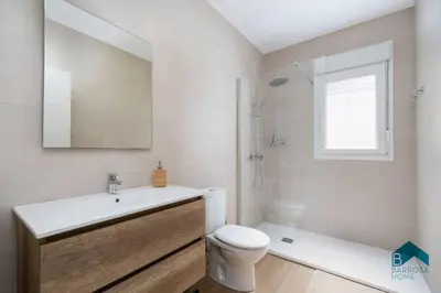 a bathroom with a sink and a toilet and a window at Bisonte C in Chiclana de la Frontera