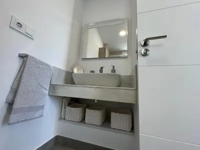 a bathroom with a sink and a mirror at La casa de Pepo in Conil de la Frontera