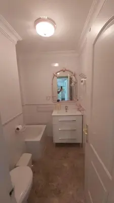 a bathroom with a sink and a toilet and a mirror at Casa Carmen in Sanlúcar de Barrameda