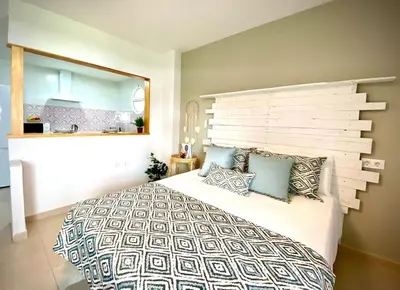 a bedroom with a large bed with pillows on it at MyChoice Alegria in Rota