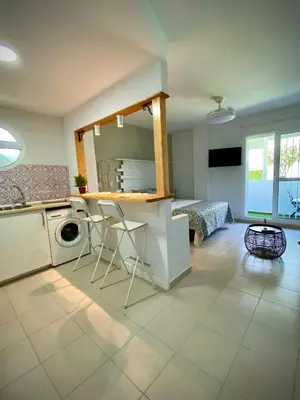 a kitchen with a washing machine and a table at MyChoice Alegria in Rota
