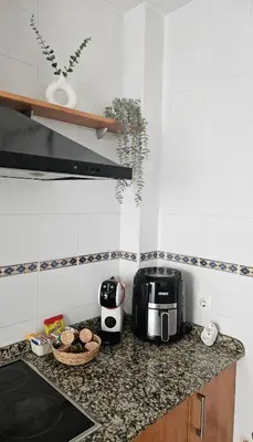 a kitchen with a counter top with a toaster and a microwave at SOL Y PLAYA in San Fernando