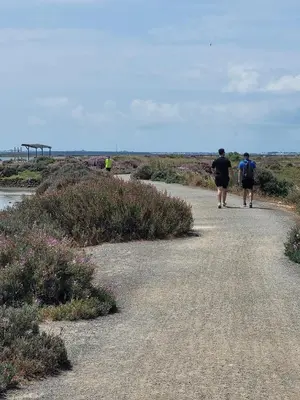 two people walking down a dirt road at SOL Y PLAYA in San Fernando