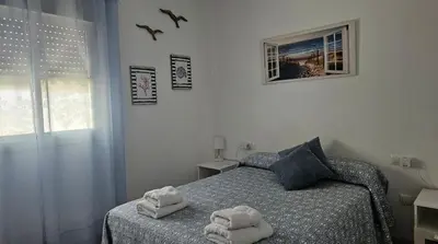 a bedroom with a bed with towels on it at SOL Y PLAYA in San Fernando