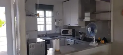 a kitchen with white cabinets and a stove top oven at Casa Pio Pio in Novo Sancti Petri