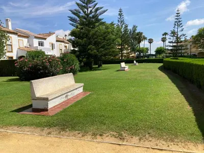 a park with a bench in the grass at Casa Pio Pio in Novo Sancti Petri