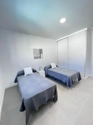 a room with two beds in a room at GRANIZO B in Chiclana de la Frontera