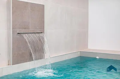 a swimming pool with a water fountain at GRANIZO B in Chiclana de la Frontera