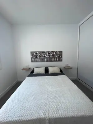 a white bedroom with a large white bed at GRANIZO B in Chiclana de la Frontera