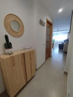 a living room with a mirror on the wall at Apartamento en Jerez 3 dormitorios y 2 baños in Jerez de la Frontera