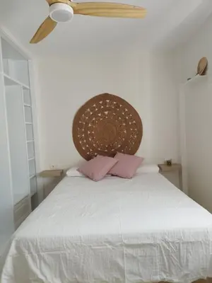 a white kitchen with lots of drawings on the wall at Apartamento en Jerez 3 dormitorios y 2 baños in Jerez de la Frontera