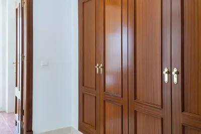 a pair of wooden cabinets in a room at Apartoyou - Soto de Vistahermosa in El Puerto de Santa María