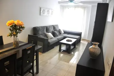 a living room with a couch and a table at Apartamento Jilguero con parking individual privado in Sanlúcar de Barrameda