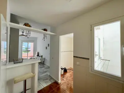 a white kitchen with a large window and a sink at costa ballena elite in Costa Ballena