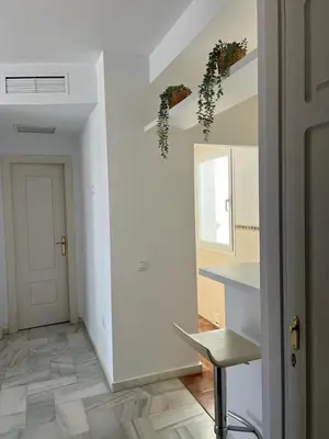 a white room with a table and a chair in it at costa ballena elite in Costa Ballena