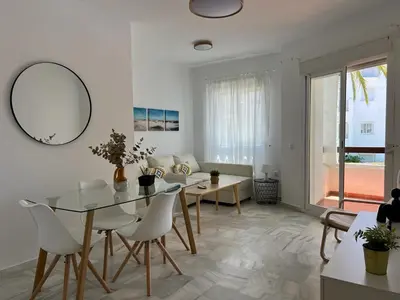 a white living room with a table and chairs at costa ballena elite in Costa Ballena