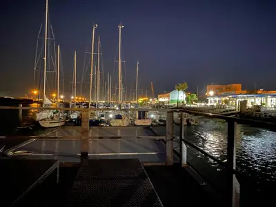 a group of boats docked in a marina at night at Houseboat Cádiz El Puerto - Casa Flotante in El Puerto de Santa María