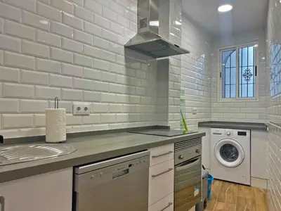 a kitchen with a sink and a washing machine at Apartamento J Burgos - Ole Solutions in El Puerto de Santa María