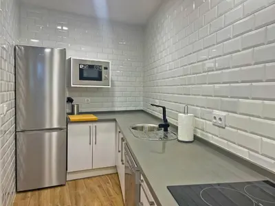 a kitchen with a stainless steel refrigerator at Apartamento J Burgos - Ole Solutions in El Puerto de Santa María