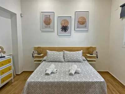 a bedroom with a bed with two towels on it at Apartamento J Burgos - Ole Solutions in El Puerto de Santa María