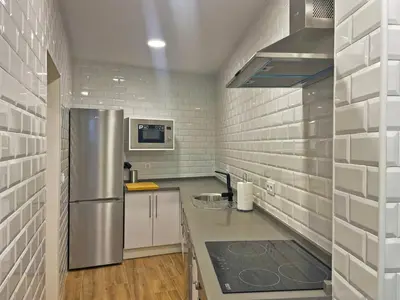 a kitchen with a stainless steel refrigerator at Apartamento J Burgos - Ole Solutions in El Puerto de Santa María