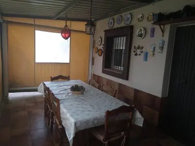 a dining room with a table and chairs and plates on the wall at Almajar 4 in El Puerto de Santa María