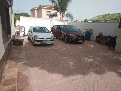 two cars parked in a brick parking lot at Almajar 4 in El Puerto de Santa María
