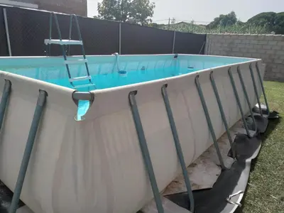 a pool with a ladder in the side of it at Almajar 4 in El Puerto de Santa María