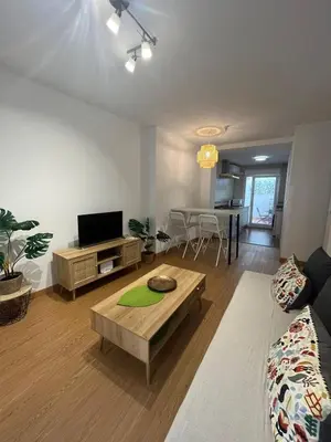 a living room with a couch and a table at Gades de la Caleta con Terraza Grupo AC Gestion in Cádiz