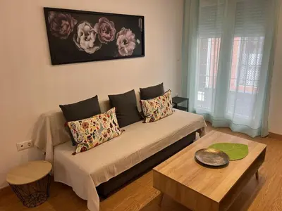 a living room with a couch and a table at Gades de la Caleta con Terraza Grupo AC Gestion in Cádiz