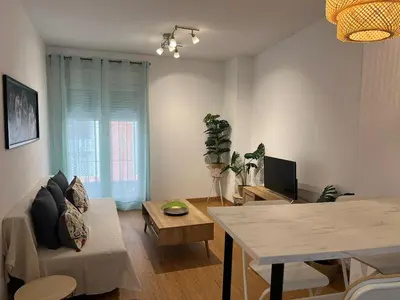 a living room with a couch and a table at Gades de la Caleta con Terraza Grupo AC Gestion in Cádiz