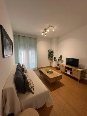 a living room with a couch and a tv at Gades de la Caleta con Terraza Grupo AC Gestion in Cádiz
