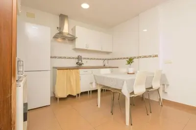 a kitchen with a table and chairs in a room at Villa Lola in Cádiz
