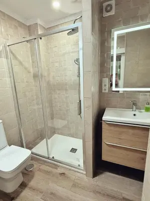 a bathroom with a shower and a toilet and a sink at Villa Lola in Cádiz