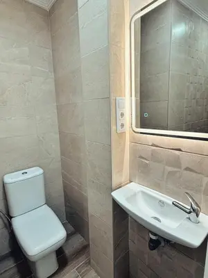 a bathroom with a white toilet and a sink at Villa Lola in Cádiz