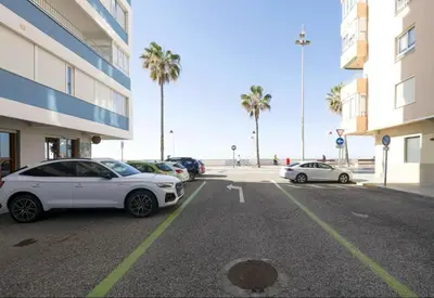 a white car parked in a parking lot next to a building at Villa Lola in Cádiz