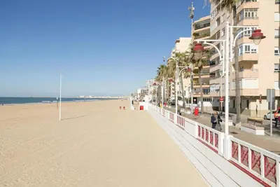 a view of a beach with buildings and condos at Villa Lola in Cádiz