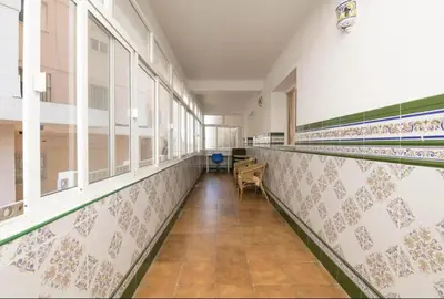 an empty hallway with tiles on the walls and windows at Villa Lola in Cádiz