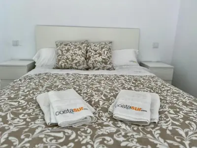 a bed with two towels on top of it at Casa El Azul in Chiclana de la Frontera