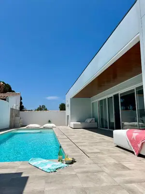 a swimming pool in front of a house at Casa El Azul in Chiclana de la Frontera
