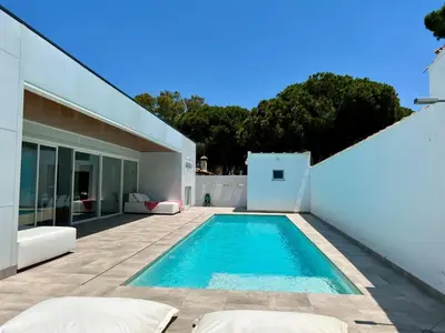 a swimming pool in the backyard of a house at Casa El Azul in Chiclana de la Frontera