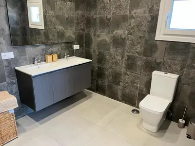 a bathroom with a toilet and a sink at Chalet El Eden in Chiclana de la Frontera
